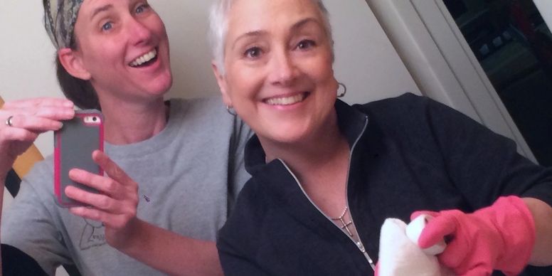 Friends taking selfie while cleaning