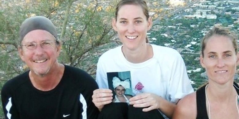 Group smiling outdoors with photo