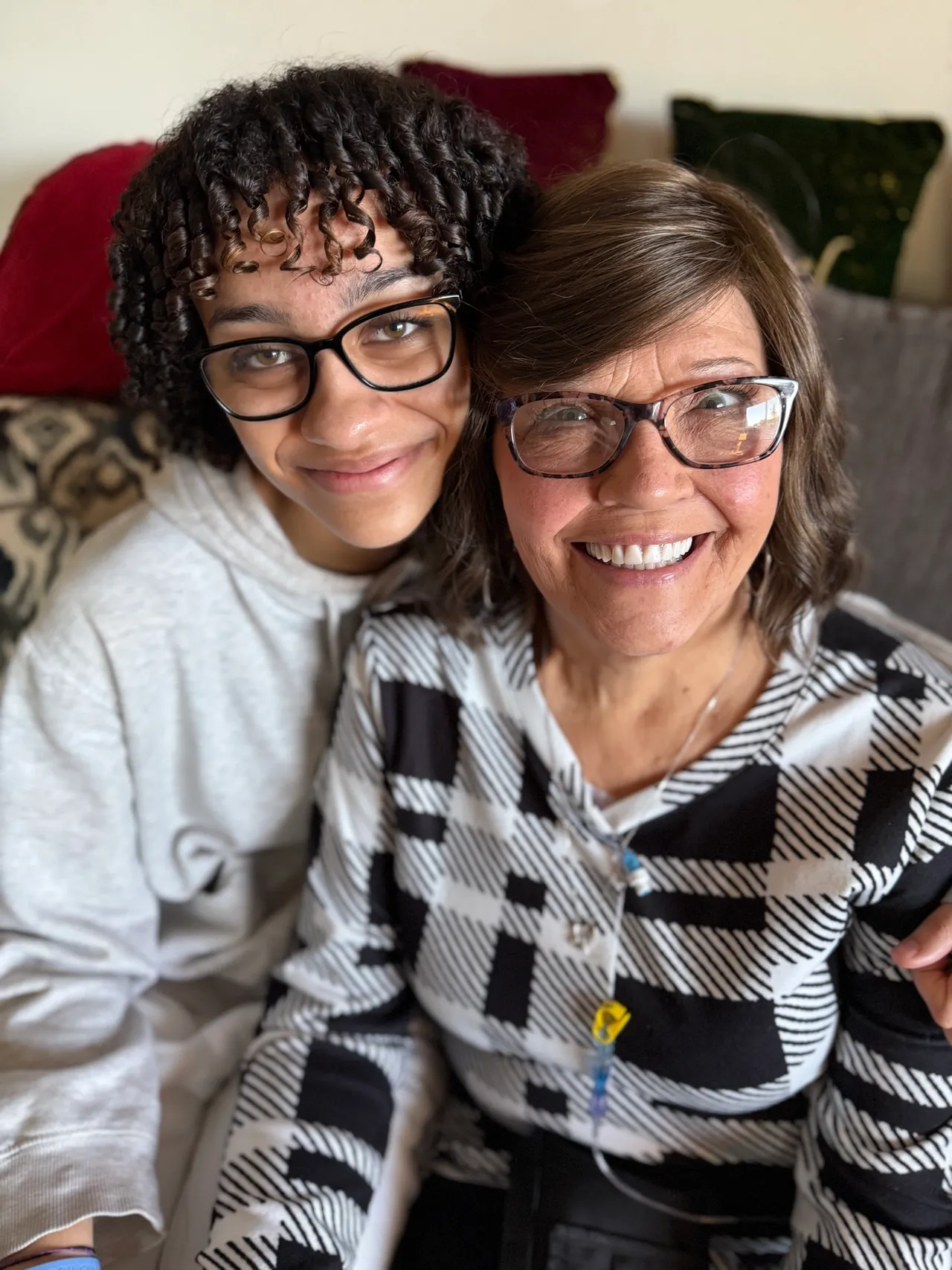 Smiling pair with glasses and cozy sweaters