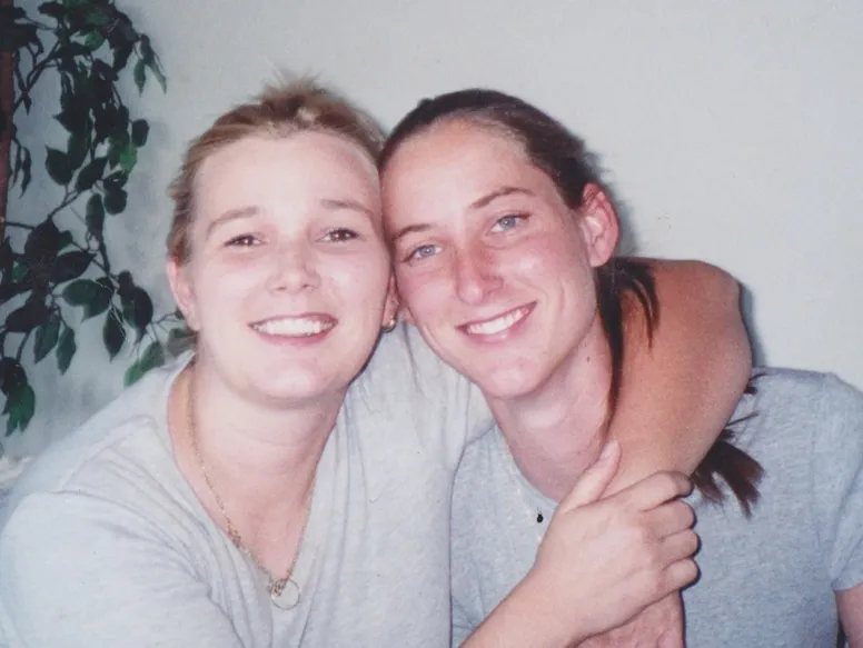 Two people smiling and embracing