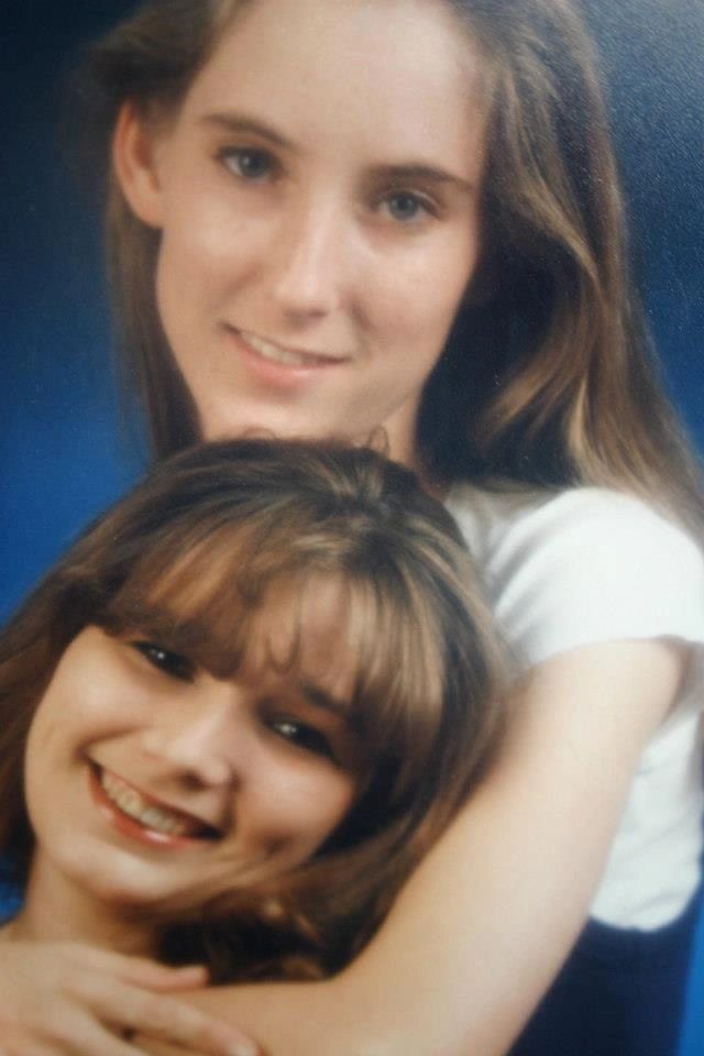 Two smiling women posing together