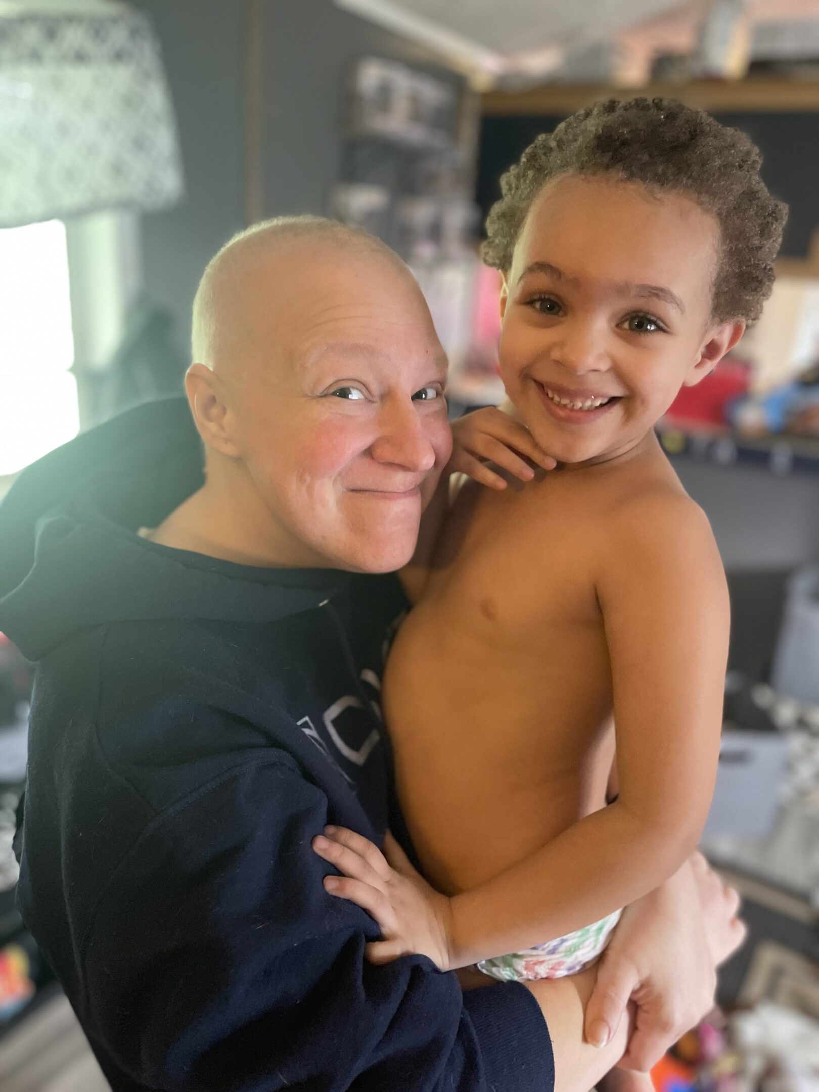A joyful moment between a smiling woman and a young boy.